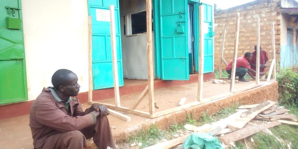 Local builders extending the verandah outside the computer lab.